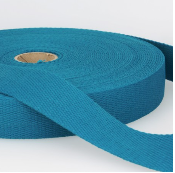 Bright blue woven cotton bias tape, ideal for sewing, tailoring, and craft projects. Durable and flexible fabric trim for professional finishing touches in dressmaking.