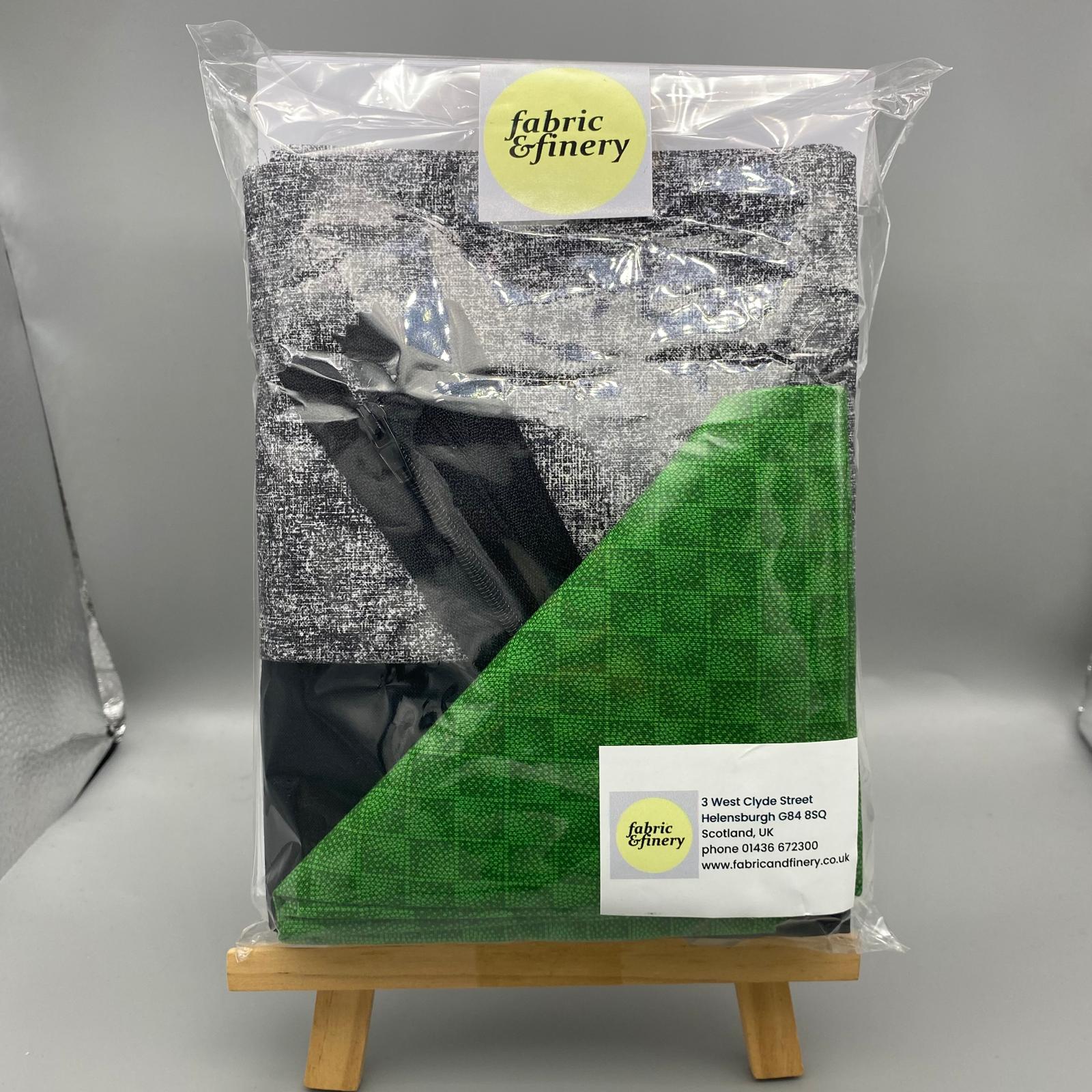 Black and grey fabric samples in clear packaging with Fabric & Finery label, suitable for upholstery, drapery, or craft projects.
