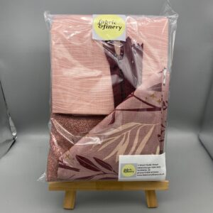 Soft pink floral patterned fabric bundle for sewing and fashion projects, available at Fabric & Finery UK. Perfect for creating stylish garments and home décor with high-quality textiles.