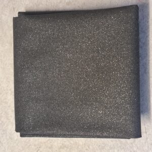 Shimmering grey fabric with glittery surface, ideal for elegant clothing and accessories. Perfect for DIY projects, evening wear, and special occasion garments. Luxurious and versatile textile material.