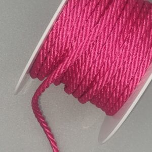 Bright pink embroidery thread on a white spool, ideal for fabric and finery sewing projects. Perfect for embroidery, craft embellishments, and detailed textile work to add vibrant colour and texture.