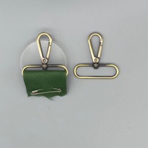 Adjustable bag purse purse strap hardware with swivel hook and fabric loop for custom bag making and sewing projects.