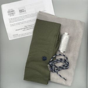 Soft grey fleece fabric with green stretch jersey, sewing thread, cord, and detailed tutorial sheet for reversible fleece with a drawstring. Perfect for DIY clothing and craft projects from fabric & finery.