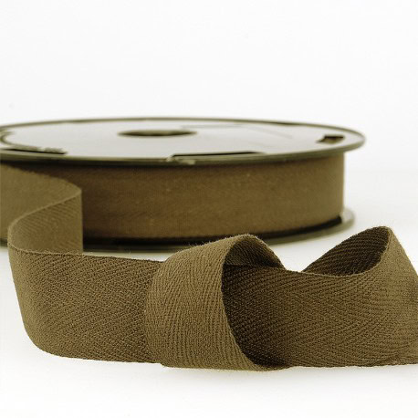 Soft khaki elastic trim for sewing, crafting, and dressmaking projects. Perfect for adding stretch and comfort to garments. High-quality fabric and finery for bespoke designs.