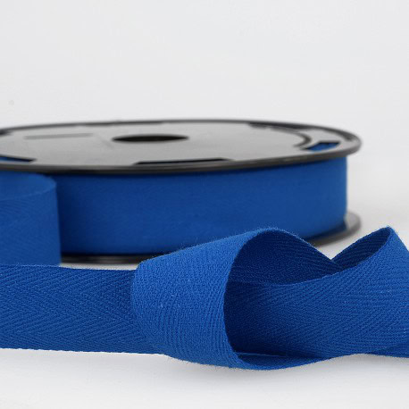 Bright blue grosgrain ribbon on a reel, perfect for sewing, crafting, and embellishments.