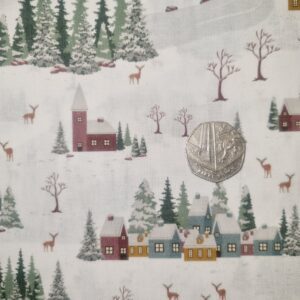 Festive winter village print fabric with snow-covered trees, small houses, and reindeer, ideal for holiday sewing projects and craft decor.