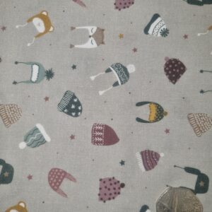 Soft woven fabric featuring playful hedgehog, bear, and fox illustrations wearing cosy hats, with scattered stars and hearts in muted pastel colours, perfect for children's clothing and nursery decor.