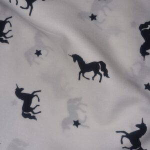 Black unicorn and star pattern fabric, whimsical and magical design ideal for children's clothing, bedding, or decor, made from high-quality textile material at Fabric & Finery.