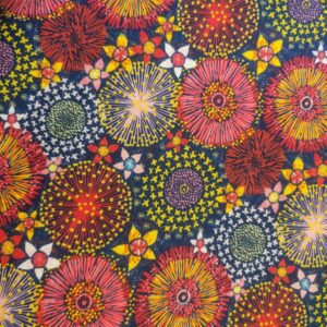 Vibrant firework-inspired fabric pattern featuring colourful explosions of yellow, red, pink, and blue on a navy background, perfect for quilting, dressmaking, and home decor projects.
