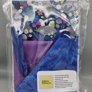 Vibrant fabric and scarf set featuring a colourful puffin and floral print, perfect for sewing projects or accessories, packaged in clear protective wrap from Fabric & Finery UK.