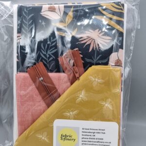 Vibrant fabric and zipper pack featuring floral and bee prints, ideal for sewing, crafting, and DIY textile projects, showcasing high-quality fabric and accessories from Fabric & Finery UK.