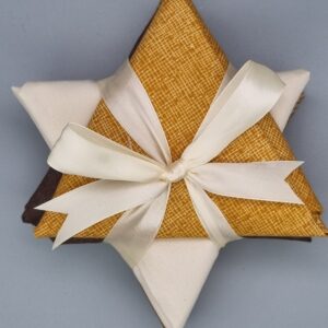 Luxurious fabric gift box wrapped with cream satin ribbon, featuring textured mustard and beige fabric, perfect for elegant fabric and finery presents.