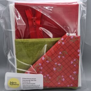 Soft red and green fabric gift wrap set with festive patterned tissue paper, ideal for holiday packaging and crafting, featuring quality textiles from Fabric & Finery.