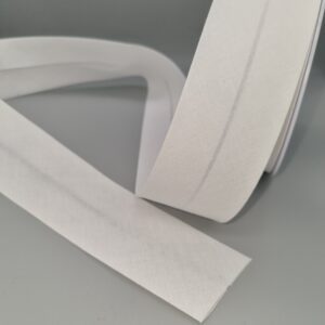 Cream silk ribbon for gift wrapping, sewing, or craft projects, featuring smooth texture and elegant finish, perfect for adding a refined touch to various decorative and fashion applications.