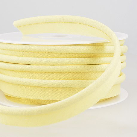 Soft yellow foam trim for sewing and crafting projects, versatile for upholstery, fashion, and home decor. High-quality fabric and finery accessories for bespoke tailoring.