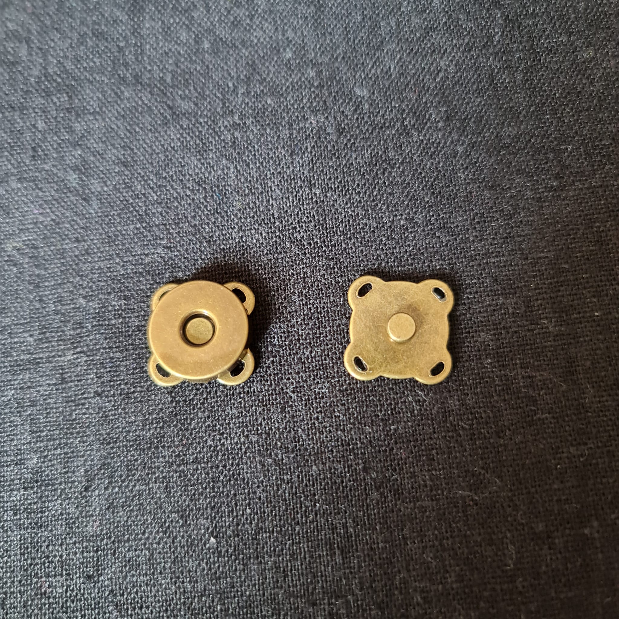 Small magnetic clasps for clothing and accessories, perfect for delicate fabric finishes and handmade garments, available at Fabric & Finery UK.