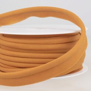 Soft tan piping cord on a white reel, ideal for bespoke upholstery, curtain making, and craft projects, offering high-quality sewing and finishing details.