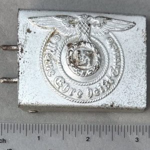 Antique silver badge with eagle and swastika emblem from WWII era.