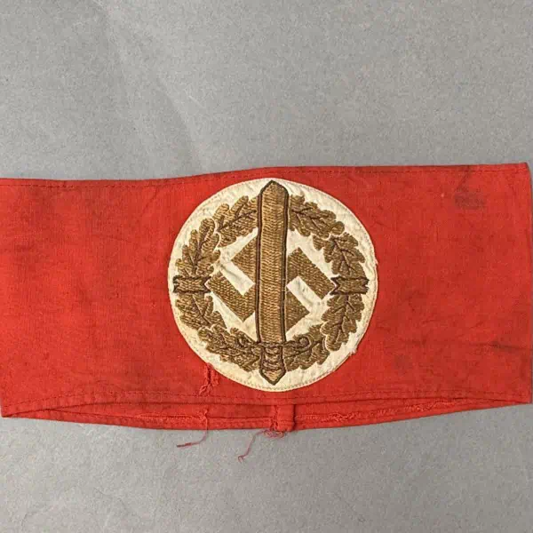 Vintage Nazi armband with swastika and oak leaf design.