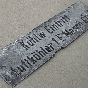 A detailed metal plaque with engraved text commemorating a Civil War soldier.