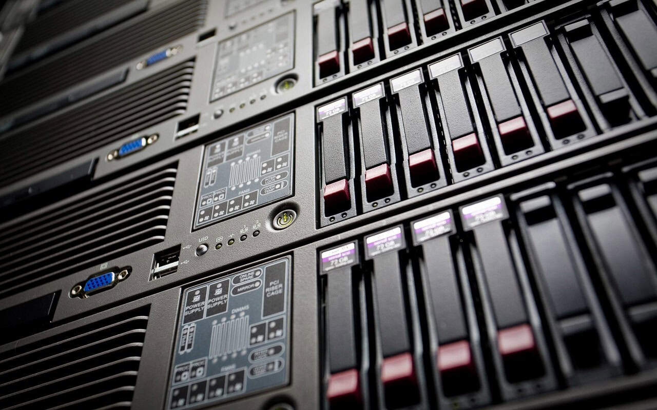 Server racks with multiple hard drives and network equipment, representing IT infrastructure for digital marketing.