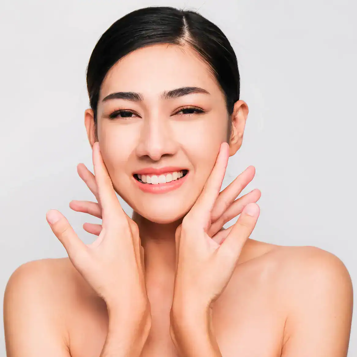 Woman with perfect skin touches her face