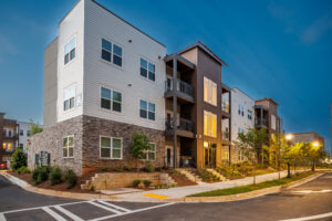Modern multi-family housing development by Gorman & Company USA showing contemporary apartments with brick and siding exterior.