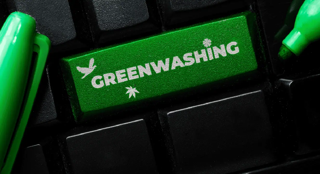 Eco-friendly green computer keyboard key with "Greenwashing" text and environmental symbols.