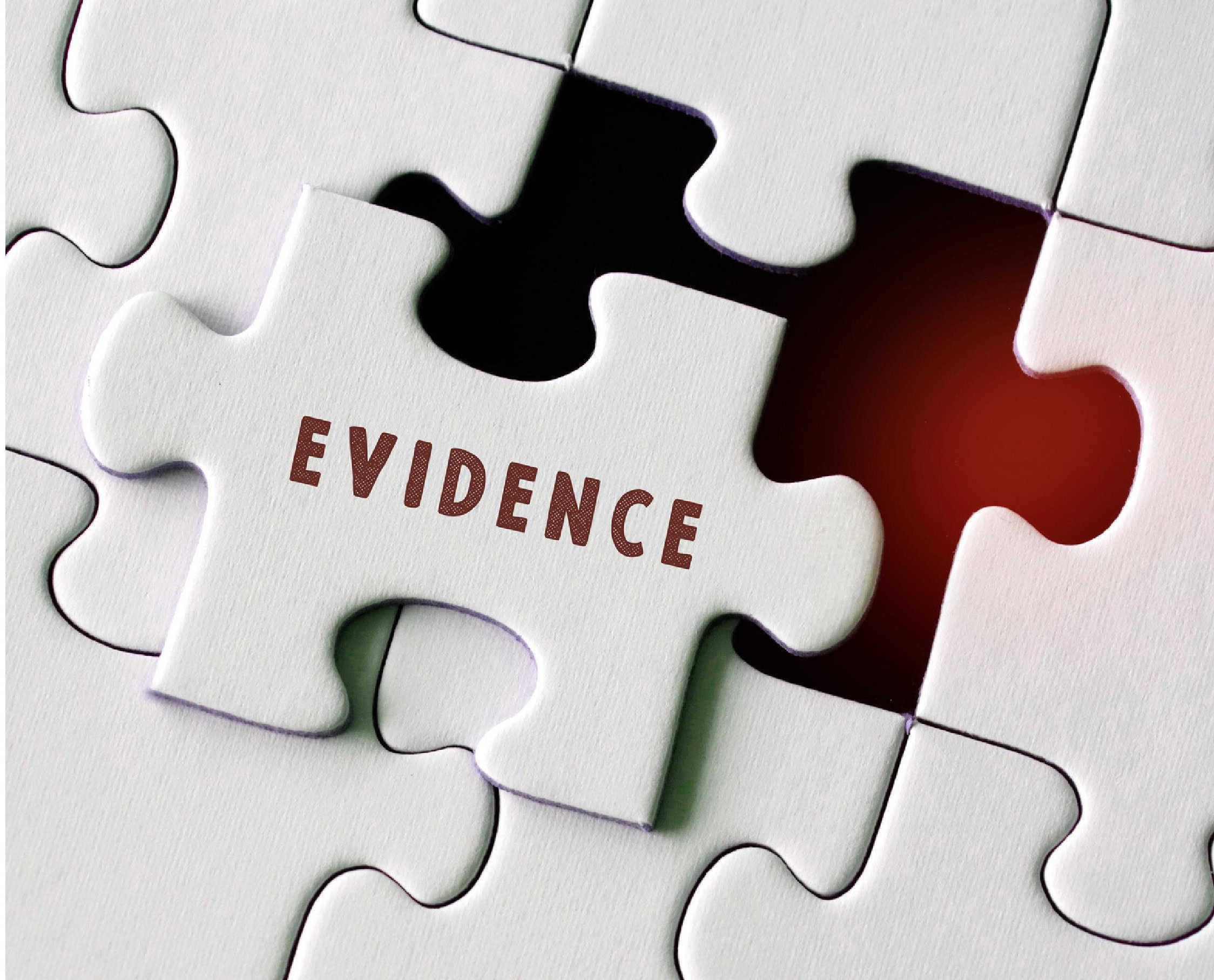 Evidence puzzle piece with the word "EVIDENCE" written on it, part of a jigsaw puzzle representing investigation and proof.