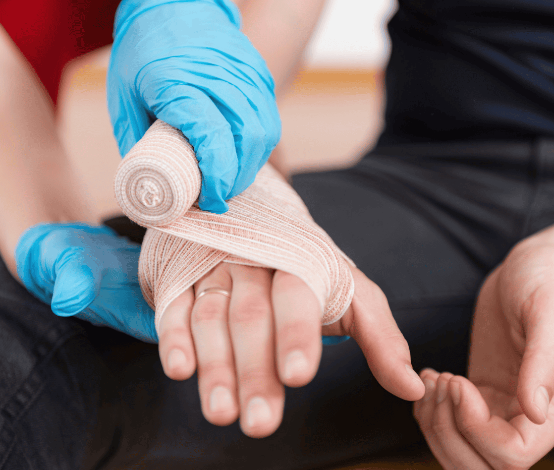 Gorvins bandaging a patient's finger with medical tape and a bandage, showing professional wound care.