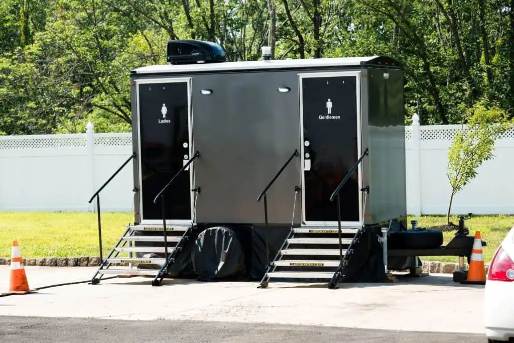 Luxury portable restroom trailer with separate facilities for ladies and gentlemen.