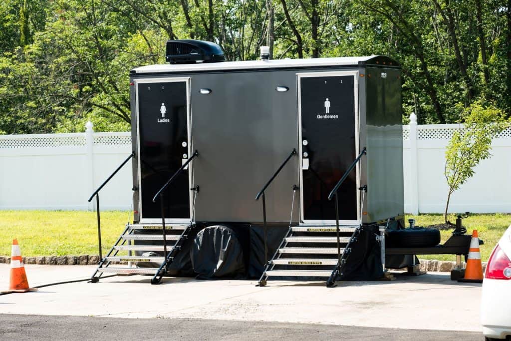 Portable restroom trailers for events with accessible features and steps.