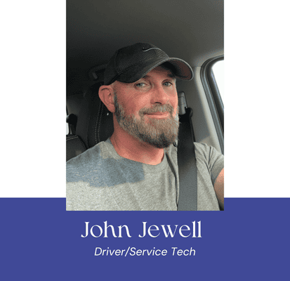 John Jewell, driver and service technician at VannGo, smiling in vehicle.