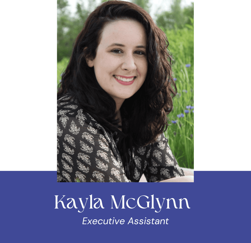 Portrait of Kayla McGlynn smiling outdoors with greenery in background.