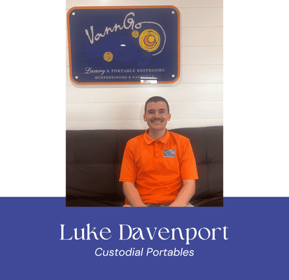 Luke Davenport, Custodial Portables staff, smiling in orange uniform at VannGo site.