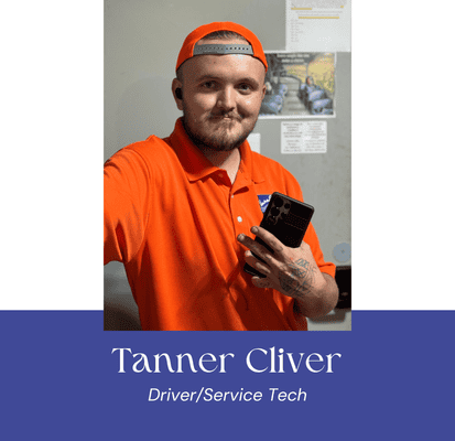 Tanner Cliver, driver and service technician at VannGo, holding a smartphone.