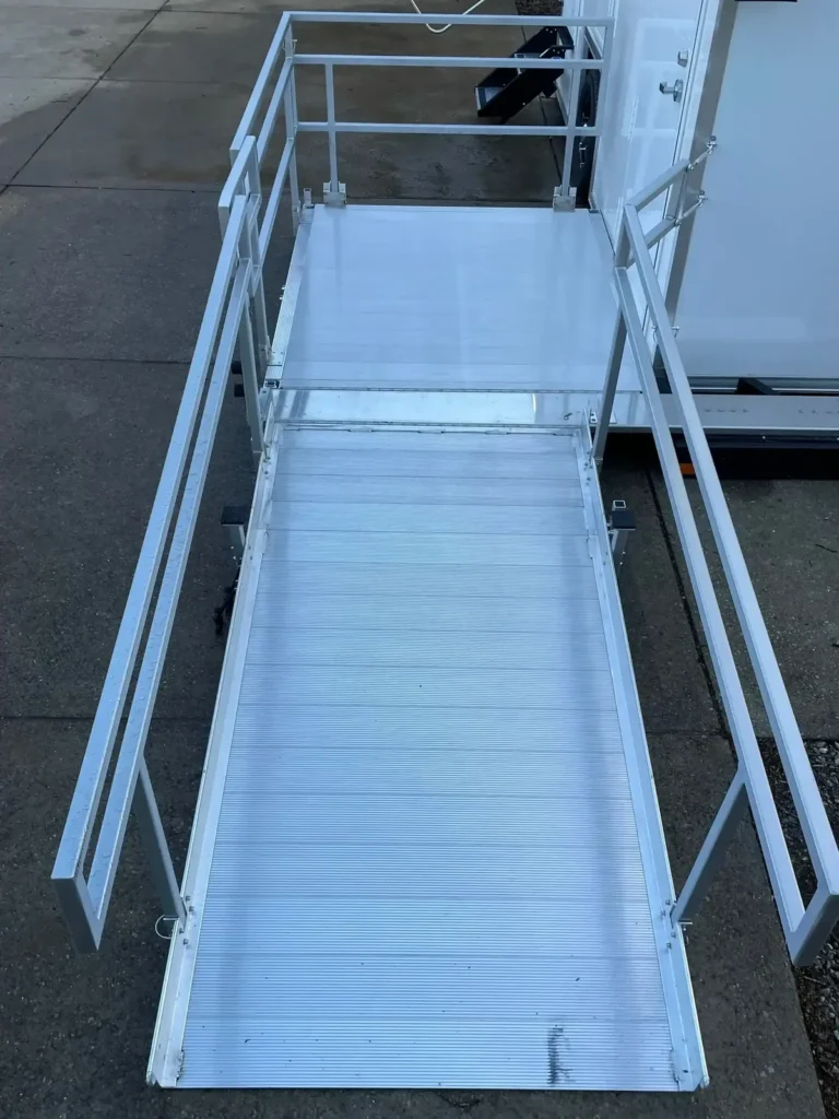 Ramp and railing on a VannGo Michelangelo ADA restroom trailer