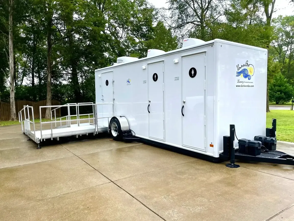 VannGo luxury restroom trailer with the company logo, set up on a paved pad