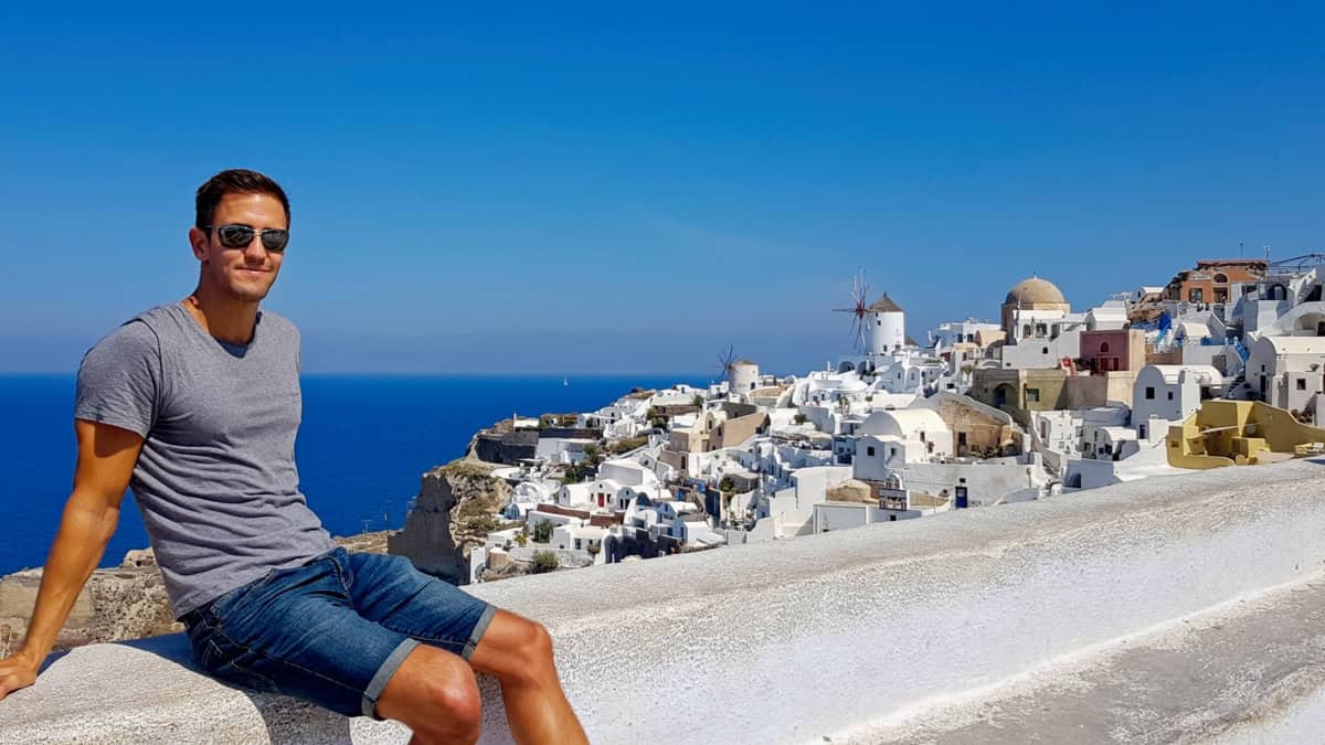 Me sitting on a wall with Oia as a backdrop
