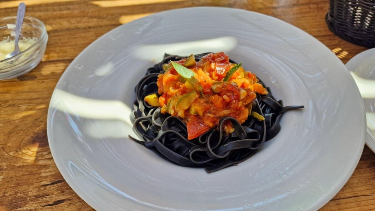 Delicious black pasta and vegetable meal at Kedros Beach Bar Donousa