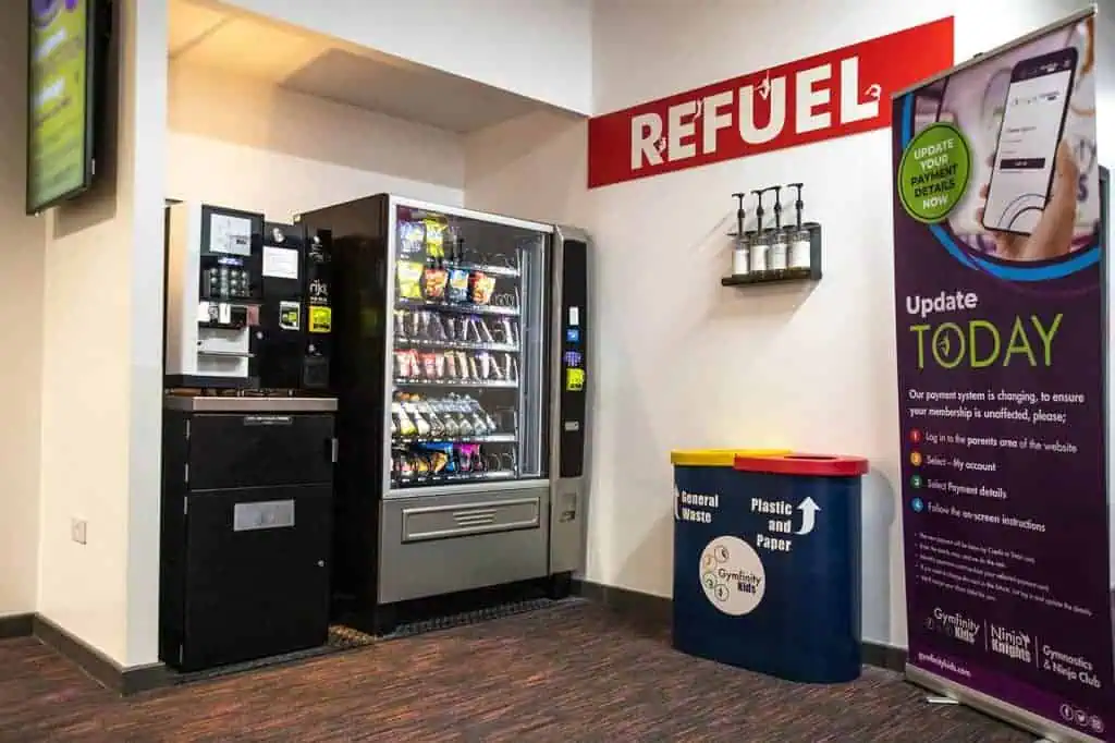Refuel station with vending machine and payment update sign at Gymfinity Kids.