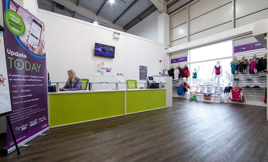 Payment system update notification at gym reception area.