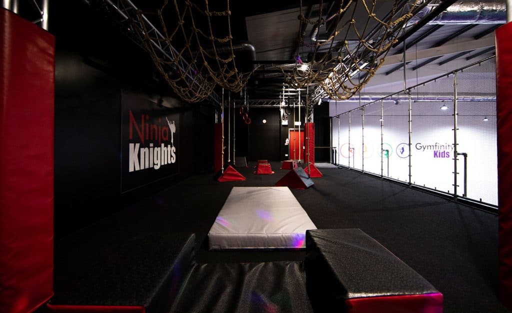 Climbing ninja warrior course with ropes, ropes and mats at Ninja Knights indoor adventure park for kids.