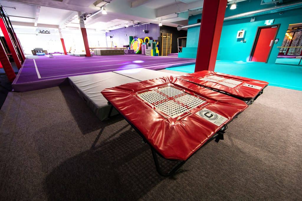 Bounce trampoline park indoor activity centre with multiple trampolines and foam pits for kids and adults in vibrant colours.