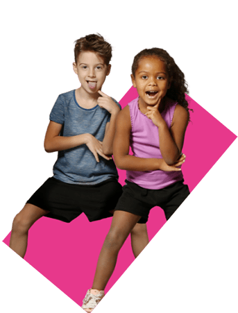 Smiling kids sitting on vibrant pink background, enjoying playful moment together.