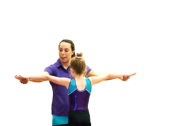 Girl gymnast receiving coaching or instructions from her coach during a training session, focusing on balance and technique, in a sports or gymnastics environment.