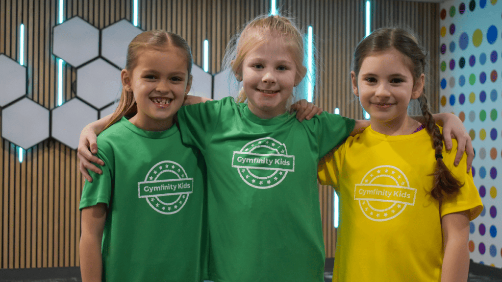 Energetic children in colourful sportswear participating in a dance or exercise class at the gym.