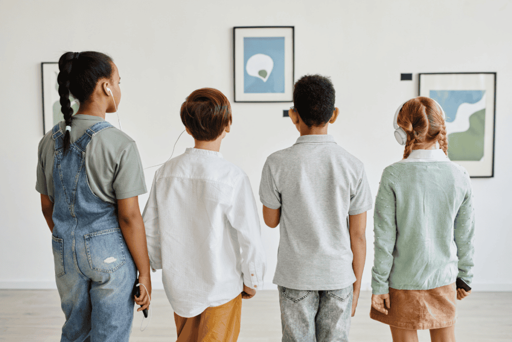 Friendship, art appreciation, children at gallery, art exhibit, kids looking at artwork, diverse group of children, museum visit, young friends exploring art, cultural education, childhood curiosity.