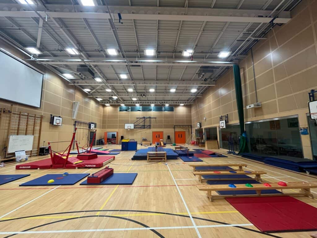 Climbing and gymnastics equipment set up in a spacious indoor gymnasium for children's activities or physical education classes. Popular for active learning, fitness, and motor skill development.