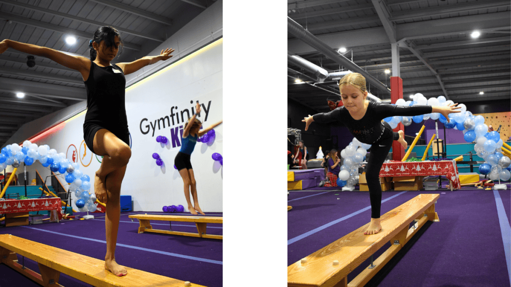 Balancing gymnasts performing on wooden beams during a gymnastics event at an indoor sports facility.